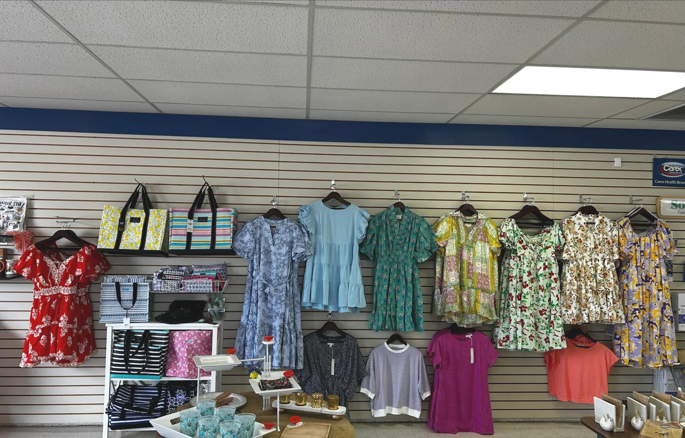 Boutique clothing wall at the Vonore Drug gift shop with dresses, totes, and gift displays