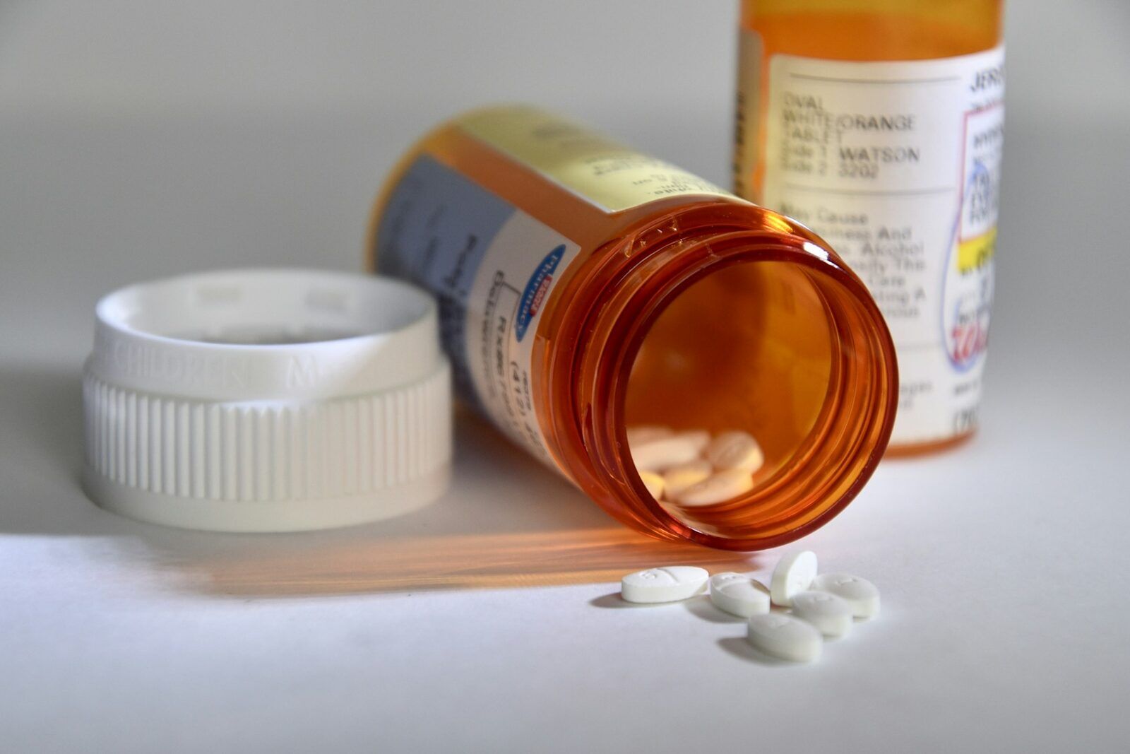 Amber prescription bottles with medication on a pharmacy counter